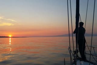 Aperitif on a sailing boat at sunset in Catania