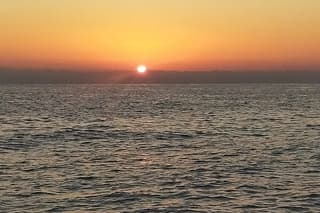 Sunset on a sailboat in the Gulf of Cagliari with aperitif