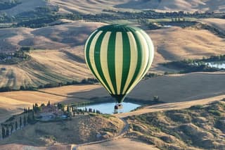 Hot air balloon over the hills of Pienza, Montalcino and Val D'Orcia