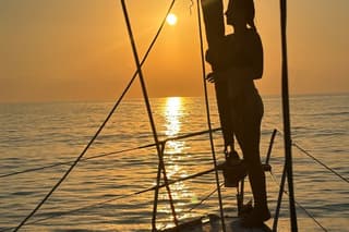 Sunset on a sailboat in the Purple Coast
